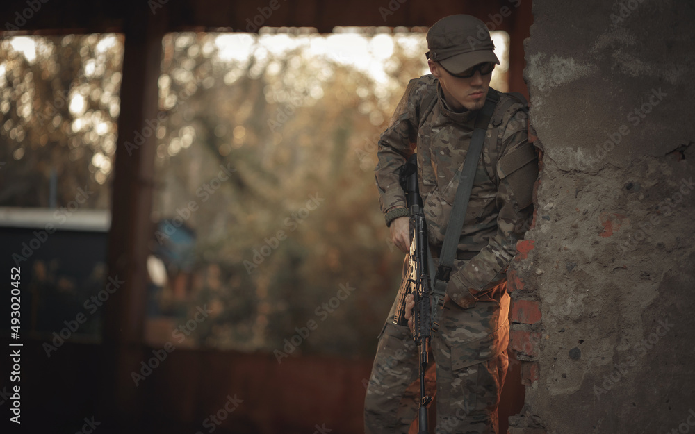 a young Ukrainian soldier with combat experience in a gray camouflage ...