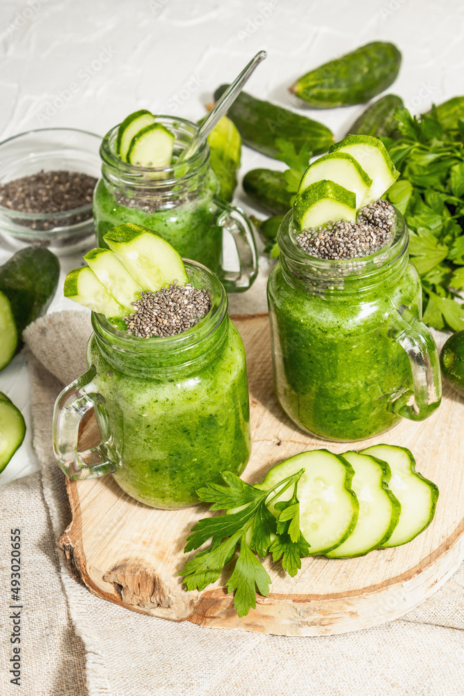 Green smoothie with cucumber in a glass jar. Fresh ripe vegetables, greens, and chia seeds Green smoothie with cucumber in a glass jar. Fresh ripe vegetables, greens, and chia seeds