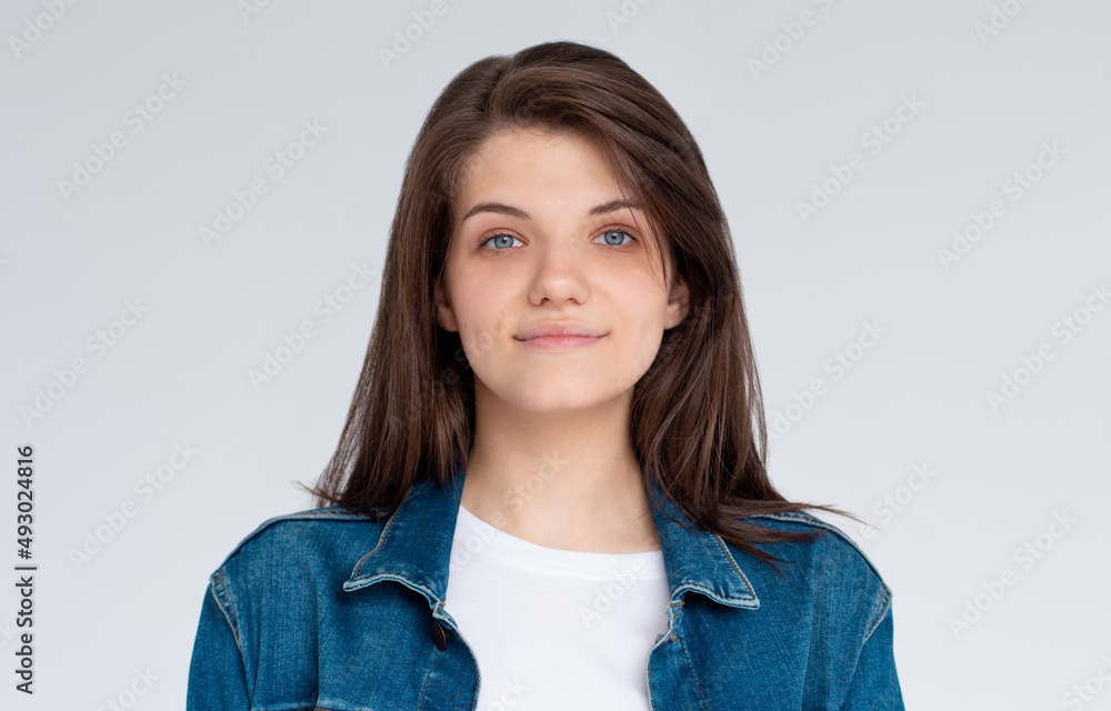Pretty smiling joyfully female with dark hair, dressed casually, looking with satisfaction at camera, being happy. Studio shot of good-looking beautiful woman isolated against blank studio wall. Pretty smiling joyfully female with dark hair, dressed casually, looking with satisfaction at camera, being happy. Studio shot of good-looking beautiful woman isolated against blank studio wall.