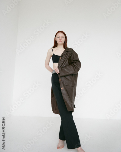 Redhead model posing in studio on white background