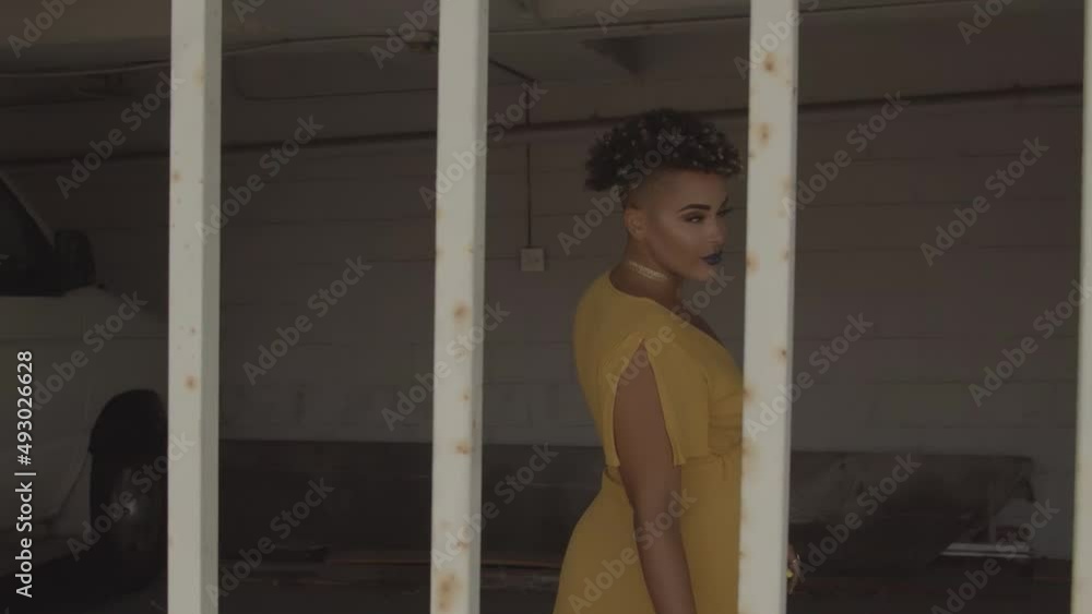Beautiful black model in yellow dress posing for the camera Beautiful black model in yellow dress posing for the camera