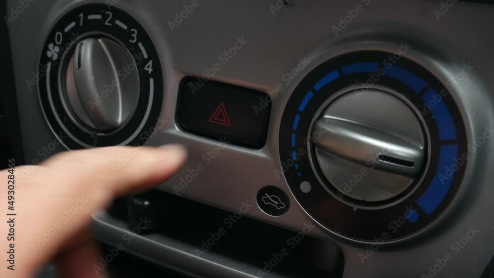 Close up of Man pressing car hazard emergency lights button in car Close up of Man pressing car hazard emergency lights button in car