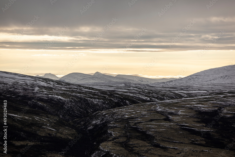 Autumn scenery in the Dovrefjell, Norway, with rocks, hills, mountains, and patches of snow