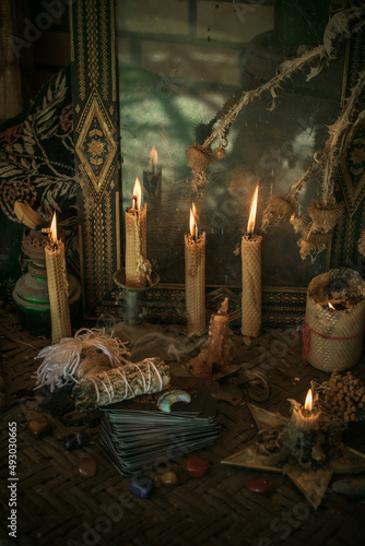 Fotografia Candle burns on the altar, powerful magic among candles, pagan or wicca concept