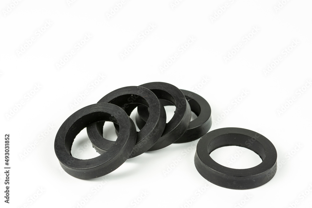 A rubber ring - a gasket, an oil seal for repairing a car brake caliper on a plane. Set of spare parts for car brake repair. Details on white background, copy space available. A rubber ring - a gasket, an oil seal for repairing a car brake caliper on a plane. Set of spare parts for car brake repair. Details on white background, copy space available.