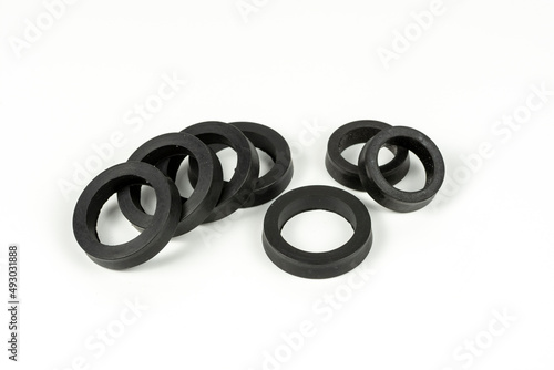 A rubber ring - a gasket, an oil seal for repairing a car brake caliper on a plane. Set of spare parts for car brake repair. Details on white background, copy space available.