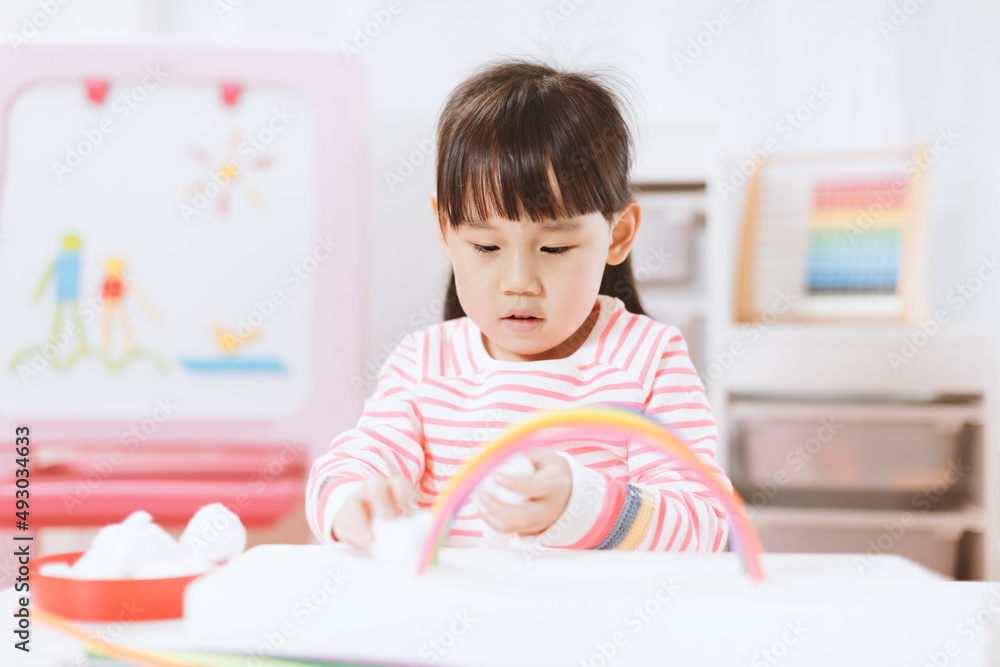 young girl making rainbow craft using pipe cleaner at home young girl making rainbow craft using pipe cleaner at home