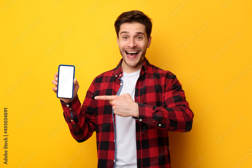 Man showing white empty smartphone screen and pointing finger Man showing white empty smartphone screen and pointing finger