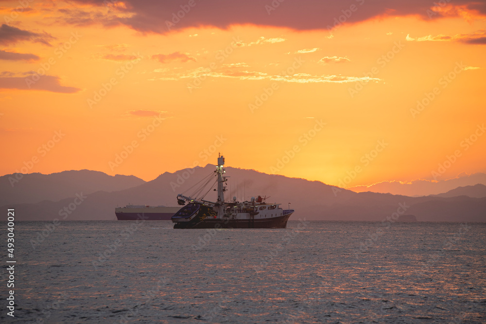 Embarking offshore with a beautiful sunset in the background Embarking offshore with a beautiful sunset in the background