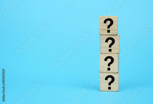 wooden block with question mark symbol on blue background, element of banner design concept. 