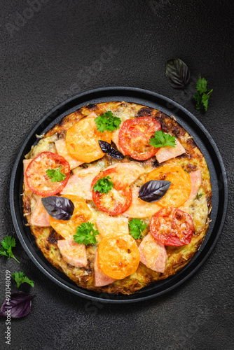 Vegetarian zucchini pizza on cast iron tray. Top view, flat lay, copy space.