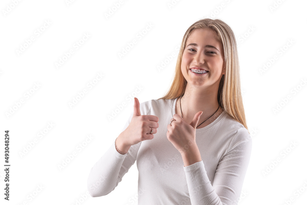 Young pretty girl with braces is showing thumbs up, isolated on white Young pretty girl with braces is showing thumbs up, isolated on white