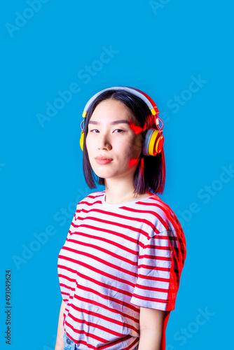 portrait young asiatic woman isolated background listening music