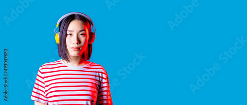 portrait young asiatic woman isolated listening music