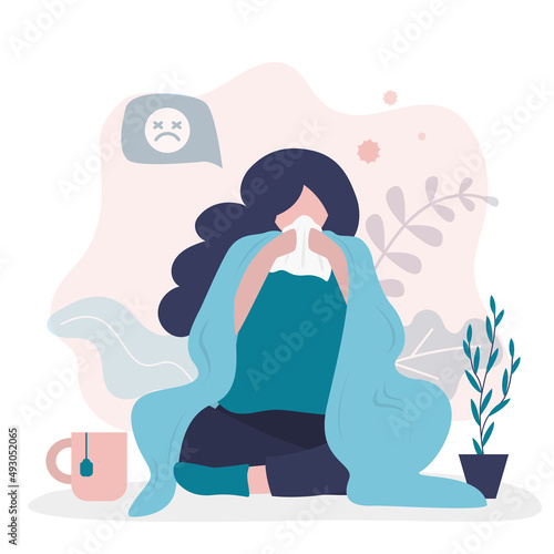 Cute girl is wrapped in blanket and blows her nose in handkerchief. woman is not feeling well. Illness, viral infection. High temperature, symptoms of onset of disease.