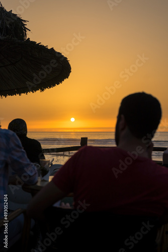 Few people enjoying their evening with a sunset view over the ocean