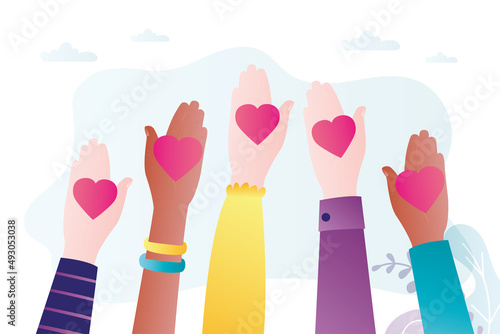 Multiethnic hands holding hearts on open palms. A call for peace and love. Movement for equality and freedom. Male and female arms. Stop war and terror.