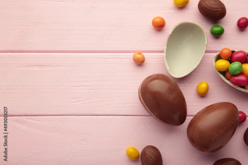 Easter composition with chocolate eggs on pink background, space for text