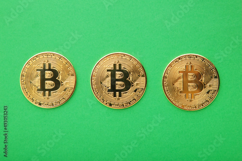 Bitcoin coin and on green background. Bitcoin growthand investment concept. photo