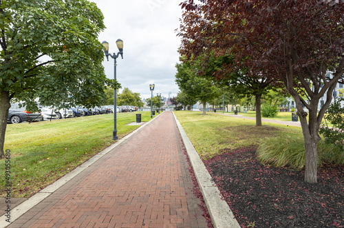A brick pathway leads towards the Delaware River waterfront in Camden, New Jersey, USA