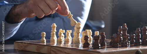 Caucasian man playing chess board game.
