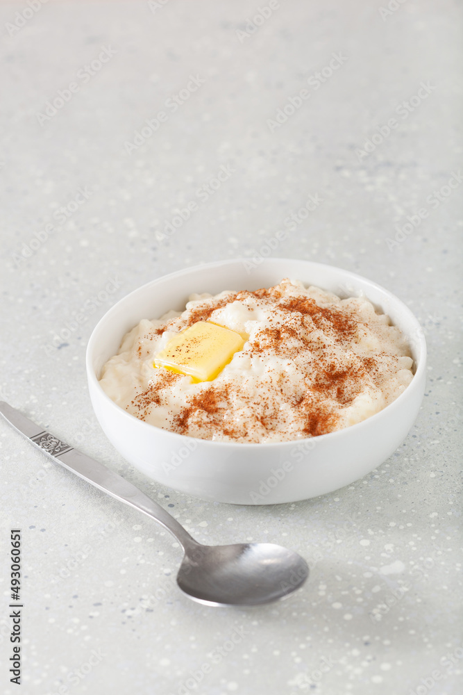 rice pudding with butter cinnamon. french riz au lait, norwegian risgrot, traditional breakfast dessert rice pudding with butter cinnamon. french riz au lait, norwegian risgrot, traditional breakfast dessert