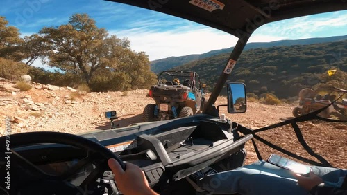 Point of view driving a buggy UTV ATV Can-am polaris on desert off-road in Ronda, Spain, on a sunny day . POV man having fun riding a ATV off-road photo