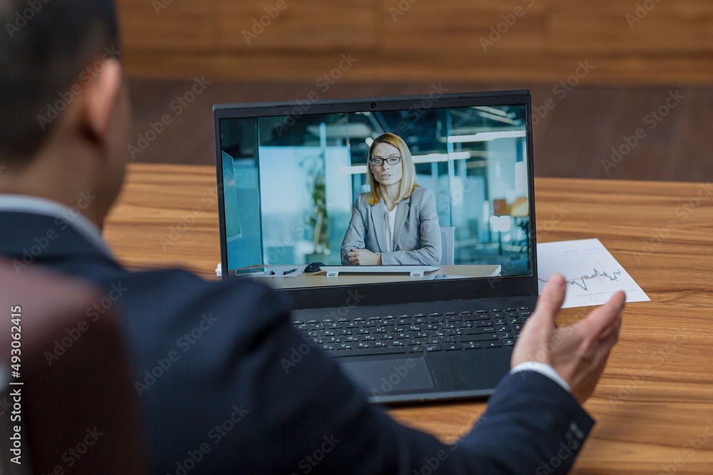 Male asian boss talking on video call with colleagues, online rally video call, boss working in classic office Male asian boss talking on video call with colleagues, online rally video call, boss working in classic office