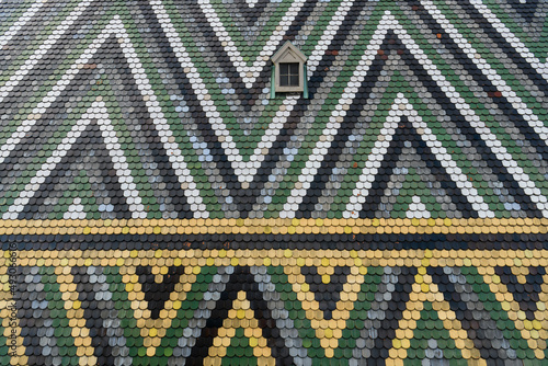 Fotografie Fragment of a patterned tiled roof of St