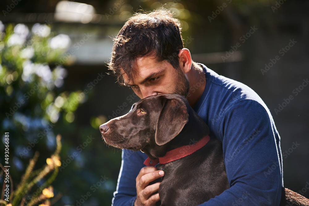 Fototapeta premium young man hugging his dog