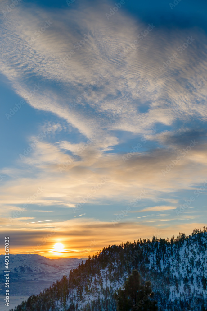 Sunrise or Sunset with Clouds over Snowy Mountain and Valley Sunrise or Sunset with Clouds over Snowy Mountain and Valley