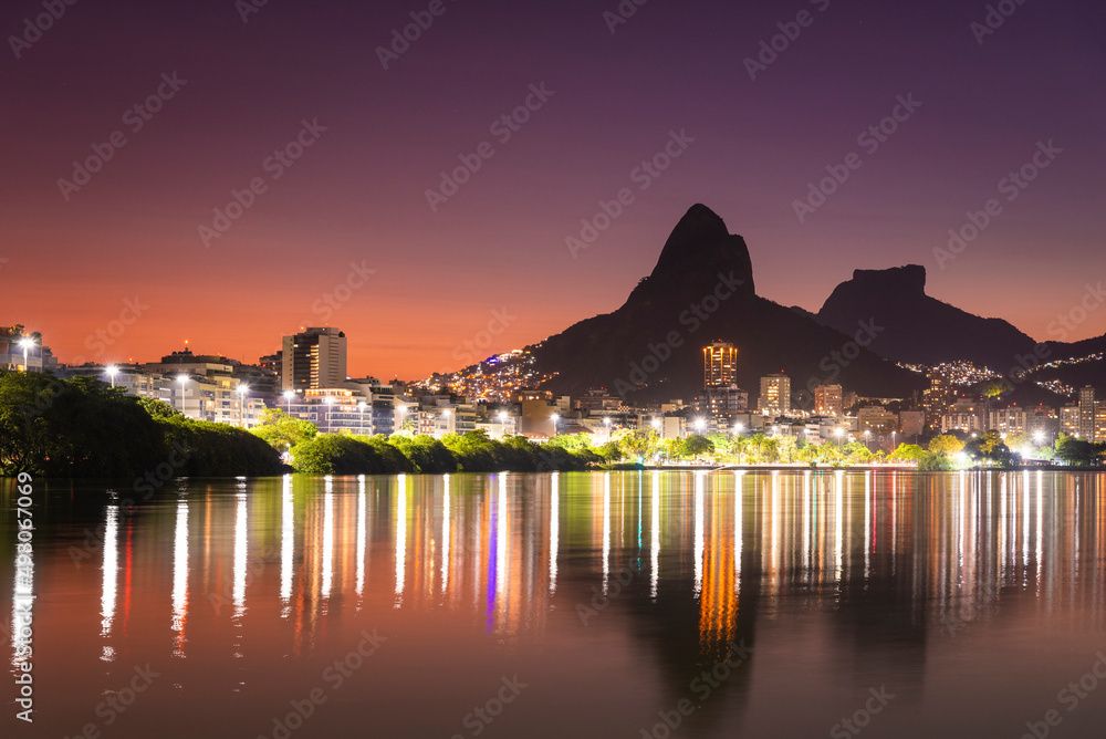 Beautiful sunset view to mountains and city lake in Rio de Janeiro