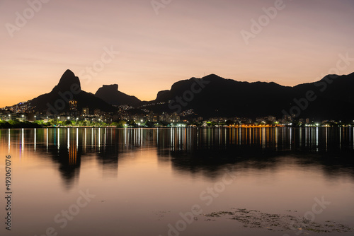 Beautiful sunset view to mountains and city lake in Rio de Janeiro