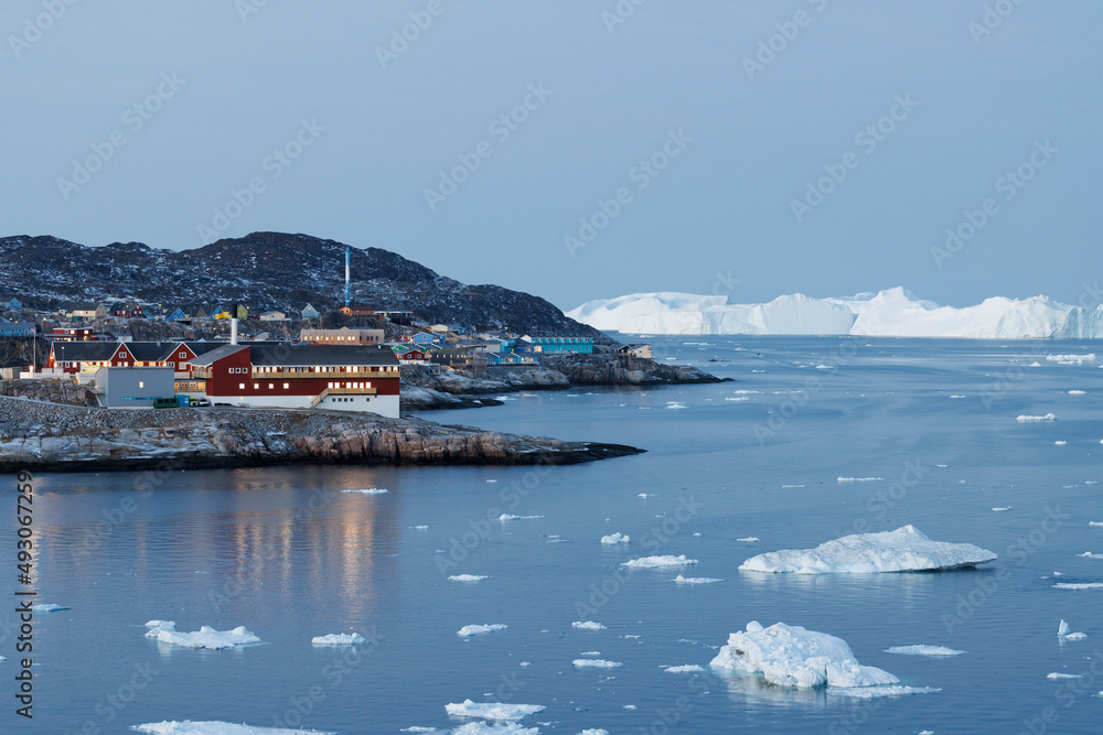 tipical artic town surrounded by big icebergs