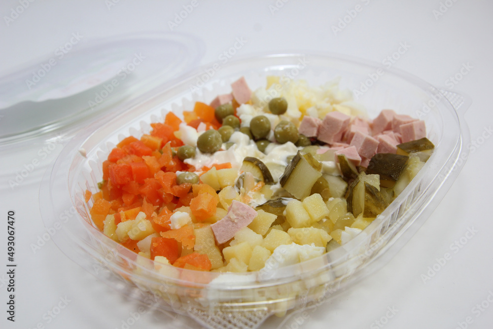 Salad Olivier in a plastic container. Lunch in a disposable dish. Salad Olivier in a plastic container. Lunch in a disposable dish.