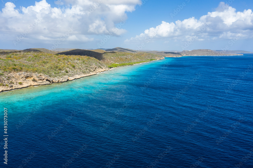 Aerial view of the coast of Curaçao in the Caribbean with beach, cliff, and turquoise ocean Aerial view of the coast of Curaçao in the Caribbean with beach, cliff, and turquoise ocean