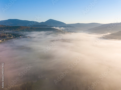 Fototapeta Naklejka Na Ścianę i Meble -  Morning fog in the Ukrainian Carpathians. Aerial drone view.