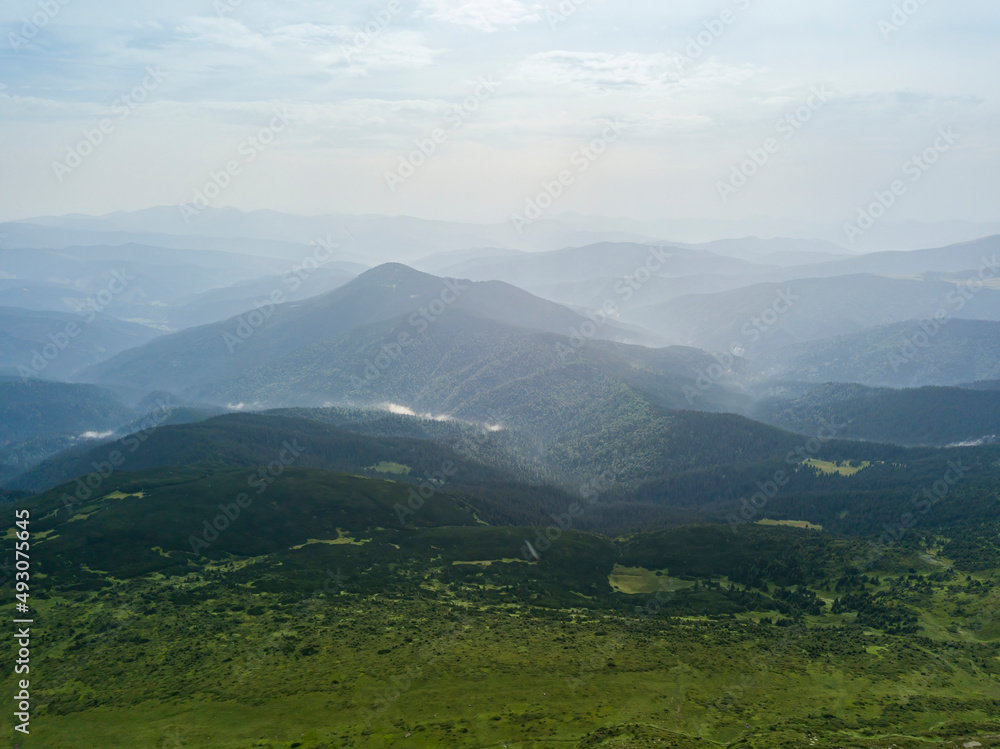 High mountains of the Ukrainian Carpathians in cloudy weather. Aerial drone view.