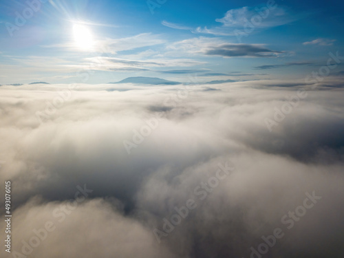 High flight above the clouds. Aerial drone view.