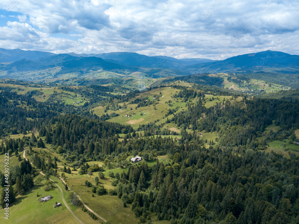 Green mountains of Ukrainian Carpathians in summer. Coniferous trees on the slopes. Aerial drone view. Green mountains of Ukrainian Carpathians in summer. Coniferous trees on the slopes. Aerial drone view.