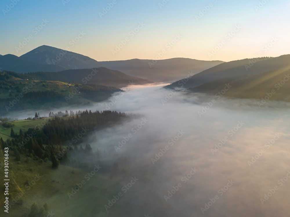 Sunrise over the fog in the Ukrainian Carpathians. Aerial drone view.