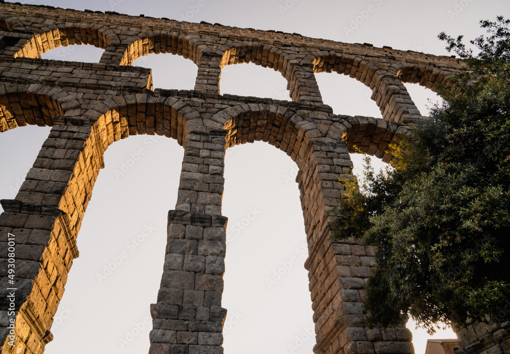 Segovia aqueduct at sunset from below looking up. Segovia aqueduct at sunset from below looking up.