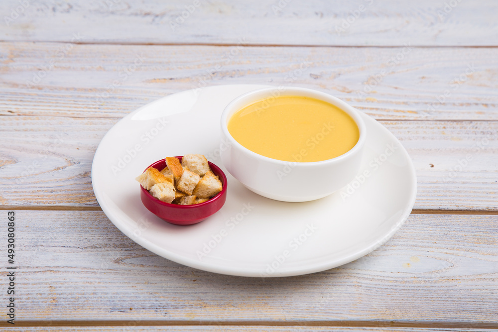 Soup prepared with special ingredients is accompanied by pieces of toasted bread. Soup prepared with special ingredients is accompanied by pieces of toasted bread.