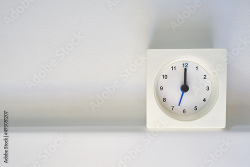 Clock on a light background with copy space. Scandinavian style in the room. Clock and time