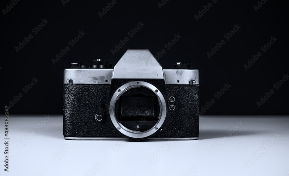 broken analog camera with fungus on the mirror, no Lense and with a black background in black and white 