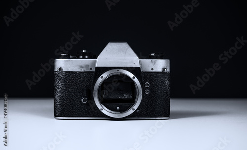 broken analog camera with fungus on the mirror, no Lense and with a black background in black and white 