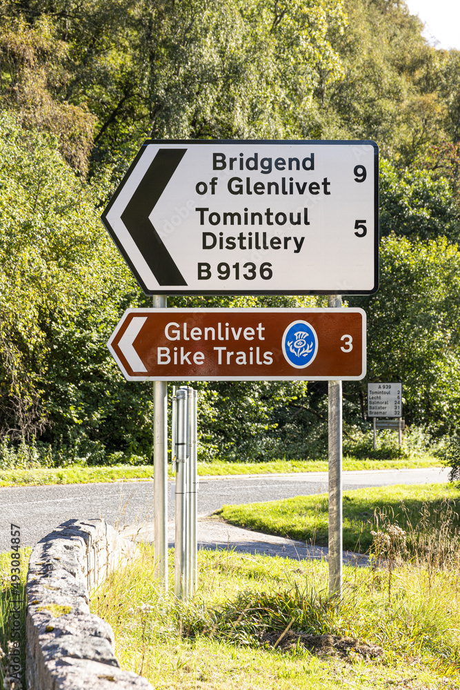 Sign for Glenlivet Bike Trails and Tomintoul Distillery at Bridge of Avon, near Tomintoul, Moray, Scotland UK.
