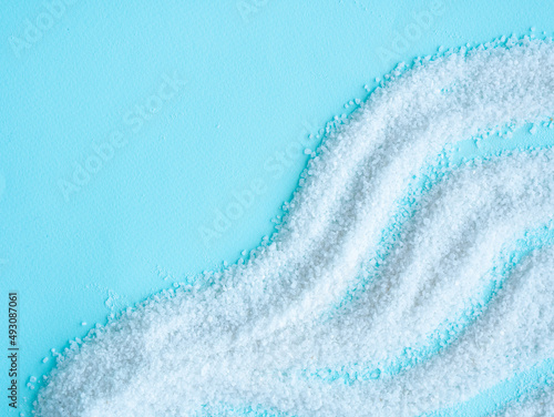 White salt is scattered on blue. Salt cave concept. background image. Place for text.