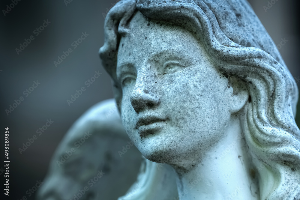 Beautiful angel as symbol of death, pain and end of human life. Fragment of an ancient statue