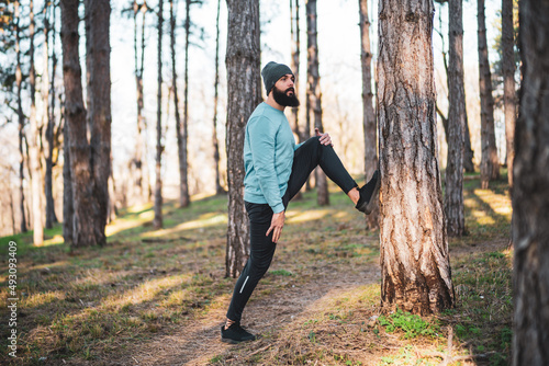 Man with beard enjoys exercising in nature.